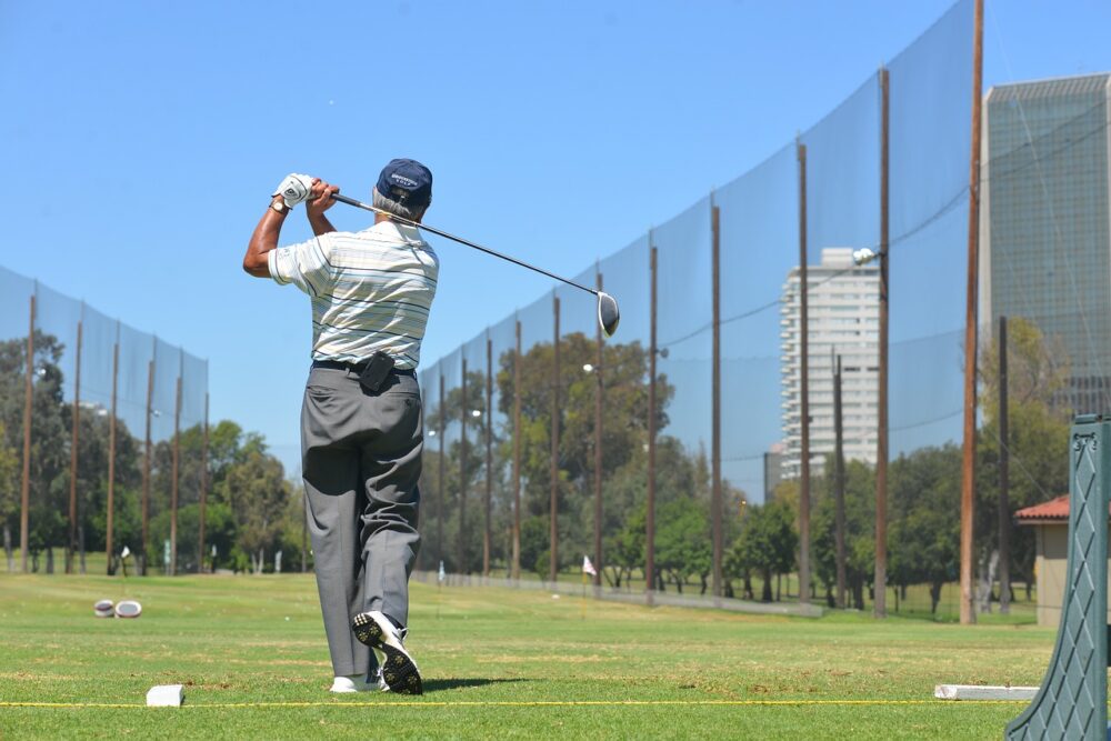 a-man-practicing-at-a-golf-driving-range