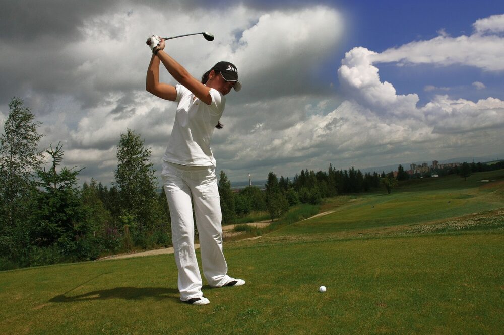 female-golfer-in-white-clothes